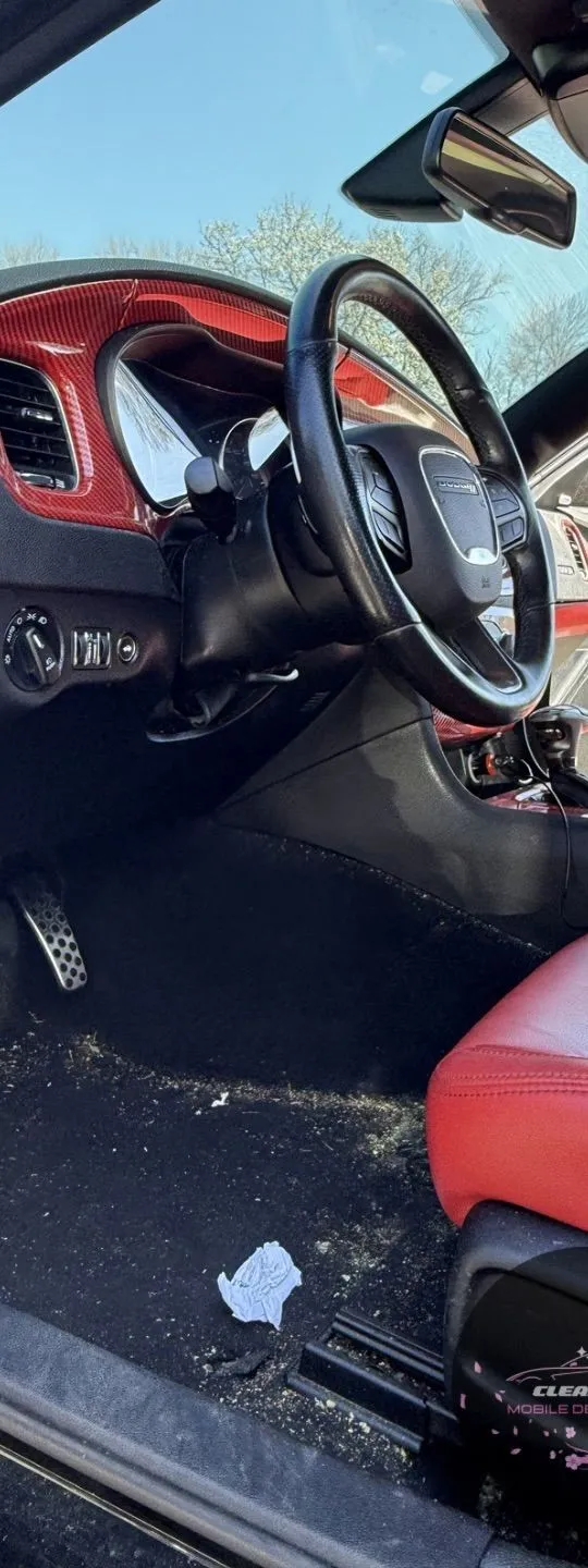 Before: red and black interior with trash and debris on the floor