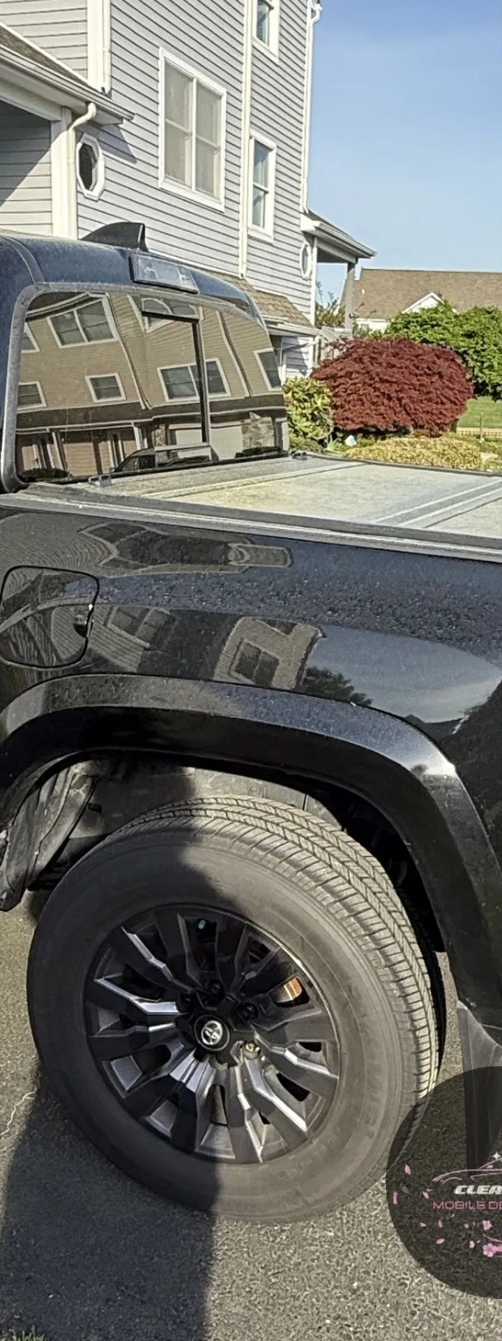 Before: dusty black truck wheel and fender