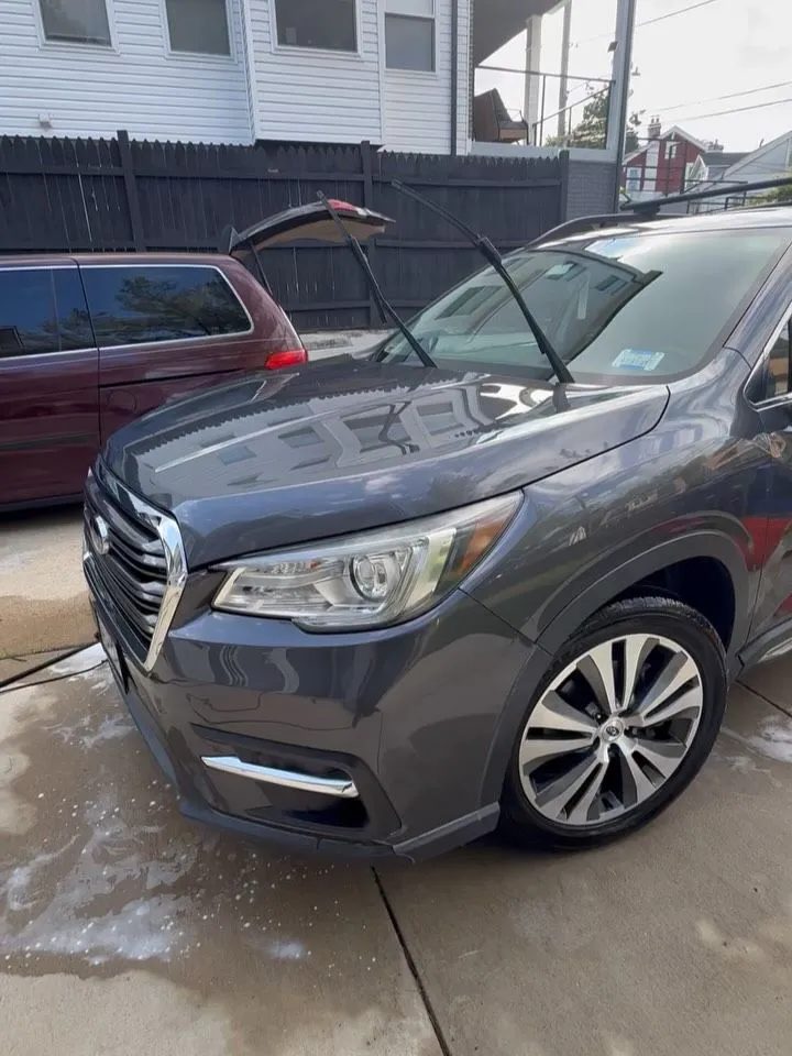 Grey Subaru Ascent with the tailgate open during a mobile detail