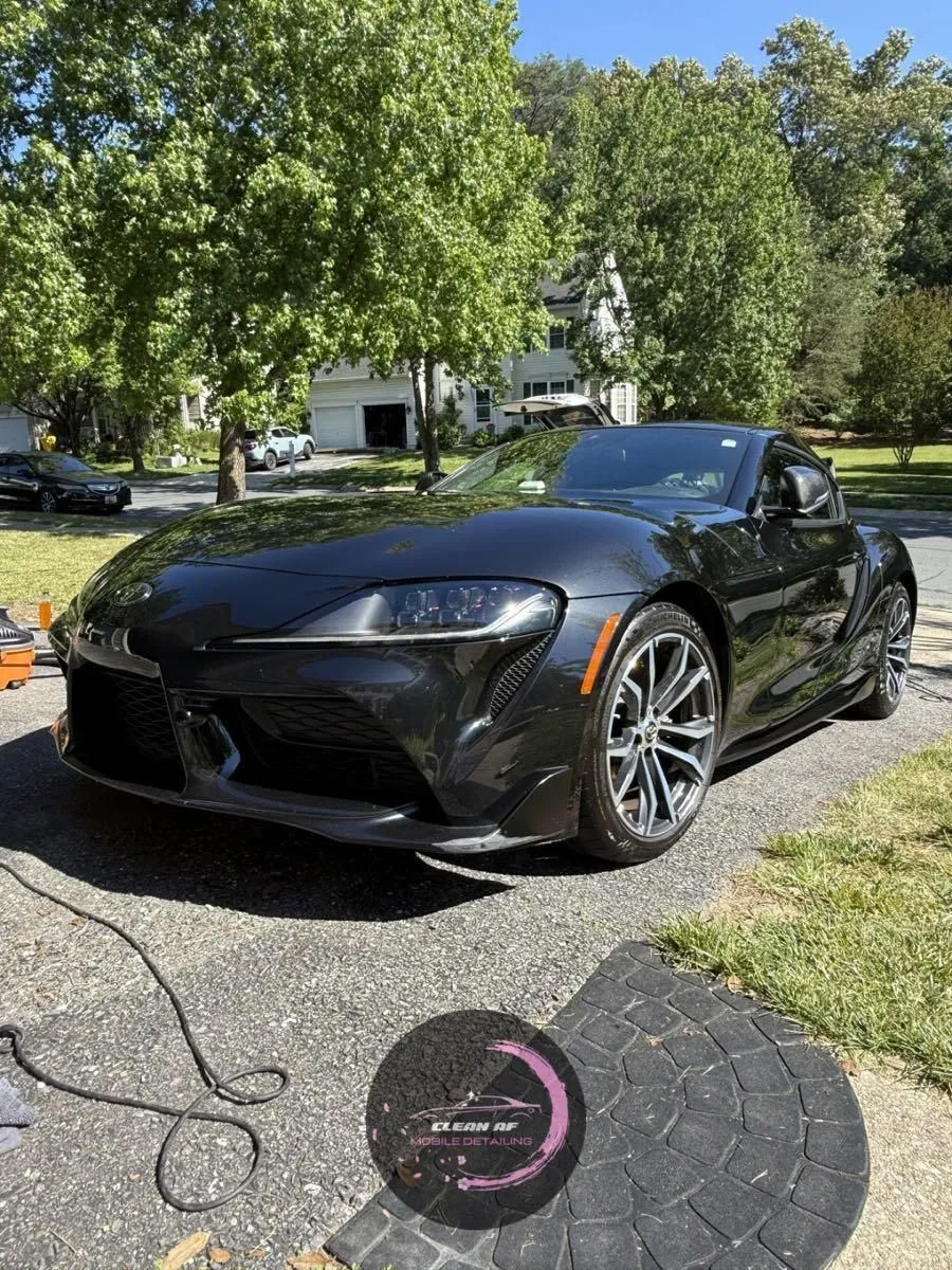 Black Toyota Supra in a driveway after an exterior detail